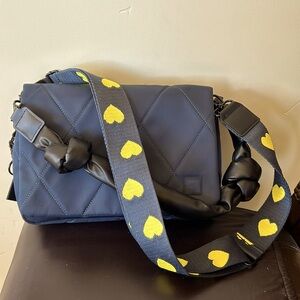 Magnetic opening, quilted,RFID, guitar strap with a black knotted strap.